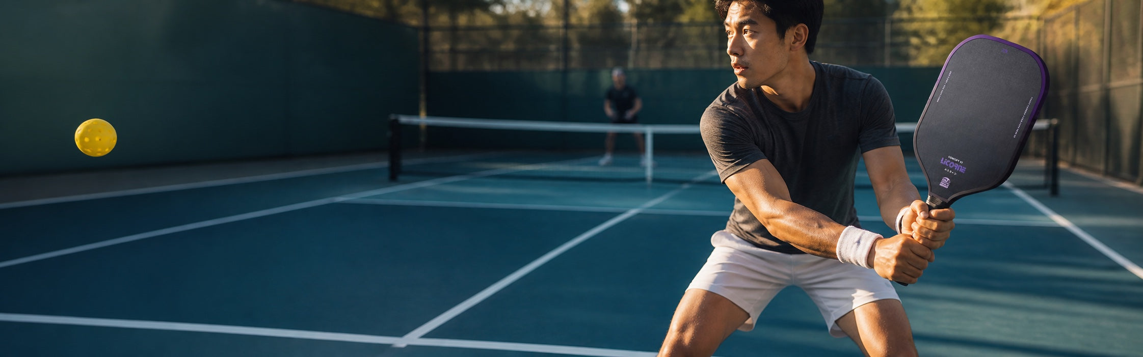 Pickleball player preparing to return a ball with a ZO paddle