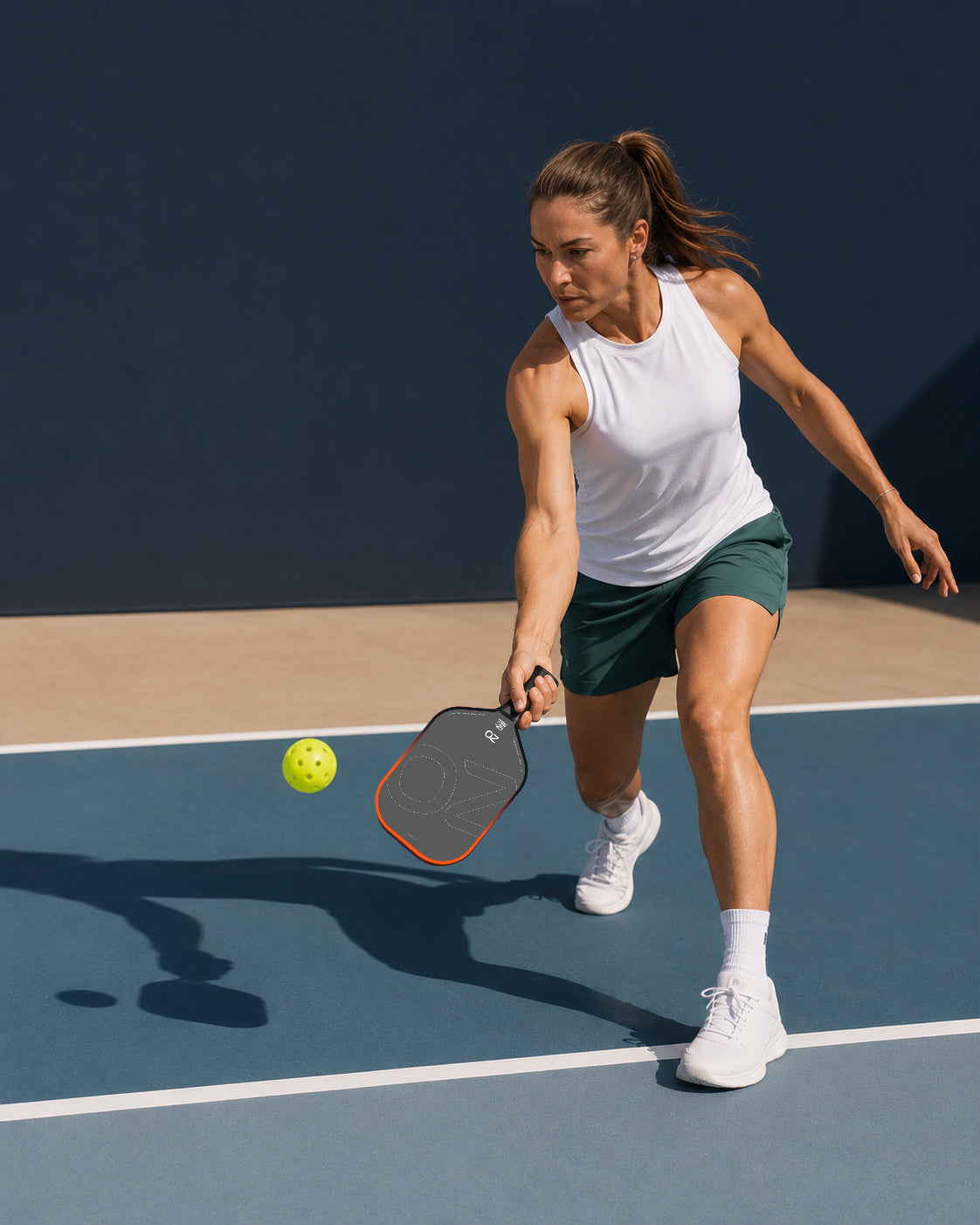 Pickleball player preparing a forehand on a blue court